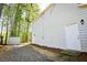 Side view of a house showing the exterior door, siding, and a small storage shed in the backyard at 3088 Mount Tabor Church Rd, Dallas, GA 30157