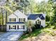Charming two-story home with stone accents, dark shutters, and a well-manicured lawn, nestled among mature trees at 3088 Mount Tabor Church Rd, Dallas, GA 30157
