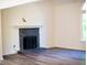 Cozy living area featuring a stone fireplace, hardwood floors, and ample natural light at 3088 Mount Tabor Church Rd, Dallas, GA 30157