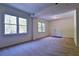 Cozy living room with plush carpeting, natural light from large windows, and neutral paint color at 3088 Mount Tabor Church Rd, Dallas, GA 30157