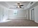 Spacious living room with a tray ceiling, ceiling fan, and neutral carpeting at 3088 Mount Tabor Church Rd, Dallas, GA 30157