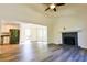 Open-concept living area with hardwood floors, a fireplace, and views into the kitchen and dining room at 3088 Mount Tabor Church Rd, Dallas, GA 30157