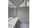 Bathroom featuring double sinks, marble floors, and a shower/tub, offering a spa-like experience at 311 Indus Ln, Lawrenceville, GA 30044