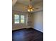 Bedroom with wood floors, ceiling fan, and a built-in bookshelf, providing comfort and functionality at 311 Indus Ln, Lawrenceville, GA 30044