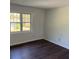 Empty bedroom featuring laminate flooring and a large window at 311 Indus Ln, Lawrenceville, GA 30044