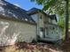 Two-story home featuring a screened in porch, deck, and light colored vinyl siding at 311 Indus Ln, Lawrenceville, GA 30044
