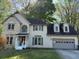 Traditional two-story home with brick and siding, featuring an attached two-car garage at 311 Indus Ln, Lawrenceville, GA 30044
