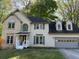 Traditional two-story home with brick and siding, featuring an attached two-car garage at 311 Indus Ln, Lawrenceville, GA 30044
