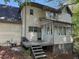 Two-story home featuring a screened in porch, wood deck, and vinyl siding at 311 Indus Ln, Lawrenceville, GA 30044