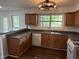 Bright kitchen featuring wood cabinets, granite countertops, and a window over the sink at 311 Indus Ln, Lawrenceville, GA 30044