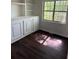 Bright office space with dark floors, built-in shelving, and natural light for a comfortable workspace at 311 Indus Ln, Lawrenceville, GA 30044
