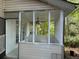 This home has a lovely screened in porch with white trim and a ceiling fan at 311 Indus Ln, Lawrenceville, GA 30044