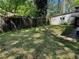 Large backyard with a mix of shade and sunlight with a wood fence at 520 Pine Dr, Pine Lake, GA 30072