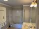 Standard bathroom with shower-tub combo, stacked washer/dryer and vanity at 520 Pine Dr, Pine Lake, GA 30072