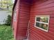 An exterior shot of a red home with white trim and a green yard at 520 Pine Dr, Pine Lake, GA 30072
