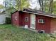 Home exterior featuring dark red siding, white trim, and an outdoor air conditioning unit at 520 Pine Dr, Pine Lake, GA 30072