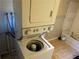 Stacked washer and dryer, with the washing machine door open, next to a bath tub at 520 Pine Dr, Pine Lake, GA 30072