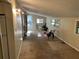 An interior shot of a living room featuring a ceiling fan, natural light, and carpeted floors at 520 Pine Dr, Pine Lake, GA 30072