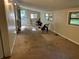 A spacious living room features natural light, carpeted floors, and access to the outdoors at 520 Pine Dr, Pine Lake, GA 30072