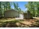 Exterior view of the rear of the house, highlighting the concrete patio and spacious yard at 5844 Earlwane Dr, Lithonia, GA 30058