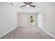 Another spacious bedroom with neutral carpet, ceiling fan, and ample natural light at 5844 Earlwane Dr, Lithonia, GA 30058
