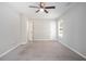 Spacious bedroom with neutral carpet, ceiling fan, and ample natural light at 5844 Earlwane Dr, Lithonia, GA 30058