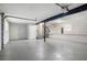 Large two car garage featuring painted walls and floors with a stairway to the upper level at 5844 Earlwane Dr, Lithonia, GA 30058