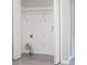 Bright laundry room features a wire shelf above the hookups and wood-look vinyl floors at 5844 Earlwane Dr, Lithonia, GA 30058