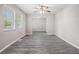 Bright living room featuring stylish gray wood-look flooring and neutral paint at 5844 Earlwane Dr, Lithonia, GA 30058