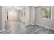 Bright living room featuring stylish gray wood-look flooring and neutral paint at 5844 Earlwane Dr, Lithonia, GA 30058