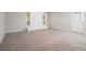 Spacious living room with light grey walls, new carpet and a white brick fireplace at 5844 Earlwane Dr, Lithonia, GA 30058