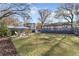 Large backyard with a fire pit, seating, and expansive lawn, offering ample space for outdoor activities at 777 Forrest Nw St, Atlanta, GA 30318
