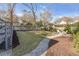 Well-manicured backyard featuring a stone walkway, grassy area, and inviting fire pit with chairs at 777 Forrest Nw St, Atlanta, GA 30318