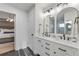 Bright bathroom with double vanity, marble countertop, dual arched mirrors, and access to the main bedroom at 777 Forrest Nw St, Atlanta, GA 30318