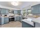 Well-lit kitchen features updated stainless steel appliances and stylish tiled backsplash at 777 Forrest Nw St, Atlanta, GA 30318