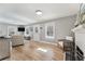Open-concept living space with hardwood floors, a fireplace, and an abundance of natural light at 777 Forrest Nw St, Atlanta, GA 30318