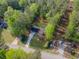 Aerial view of a property featuring a driveway, lawn and surrounded by lush green trees in a quiet neighborhood at 175 Stoneview Cir, Covington, GA 30016