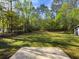 Expansive backyard with lush greenery and mature trees providing shade at 175 Stoneview Cir, Covington, GA 30016