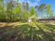 Expansive backyard with lush green grass, trees, storage shed and home in the distance at 175 Stoneview Cir, Covington, GA 30016