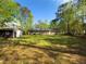 Spacious backyard with lush green grass and storage shed for outdoor equipment and activities at 175 Stoneview Cir, Covington, GA 30016