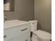 Well-lit bathroom with white vanity and toilet, and modern gold fixtures at 175 Stoneview Cir, Covington, GA 30016