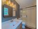 Well-lit bathroom features a sleek vanity, elegant mirror, and sliding glass door shower at 175 Stoneview Cir, Covington, GA 30016
