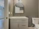 Stylish bathroom with modern vanity, arched mirror, and toilet at 175 Stoneview Cir, Covington, GA 30016