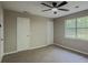This bedroom features carpet, a window, and a ceiling fan at 175 Stoneview Cir, Covington, GA 30016