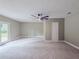Spacious bedroom features a modern ceiling fan, plush carpeting, and a door to the backyard at 175 Stoneview Cir, Covington, GA 30016