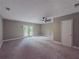 Spacious bedroom with carpet, ceiling fan, and access to the backyard at 175 Stoneview Cir, Covington, GA 30016