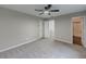 Spacious bedroom with a ceiling fan, ensuite bathroom, and plush carpeting at 175 Stoneview Cir, Covington, GA 30016