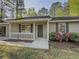 Close-up of home's front exterior, landscaped yard, and covered entry with welcoming curb appeal at 175 Stoneview Cir, Covington, GA 30016