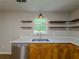 Bright kitchen featuring floating shelves and double bowl sink at 175 Stoneview Cir, Covington, GA 30016