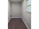 Functional laundry room features wood floors and natural light from a window at 175 Stoneview Cir, Covington, GA 30016
